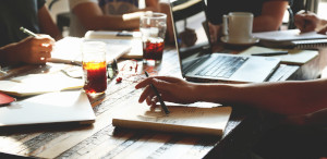 Close up of table with notebooks and a laptop